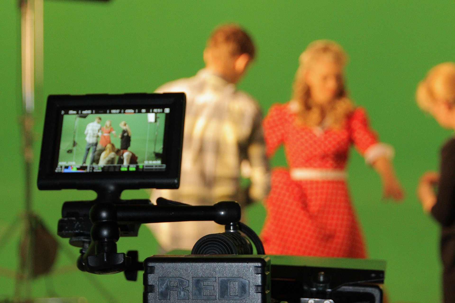 Actors in front of camera with green screen